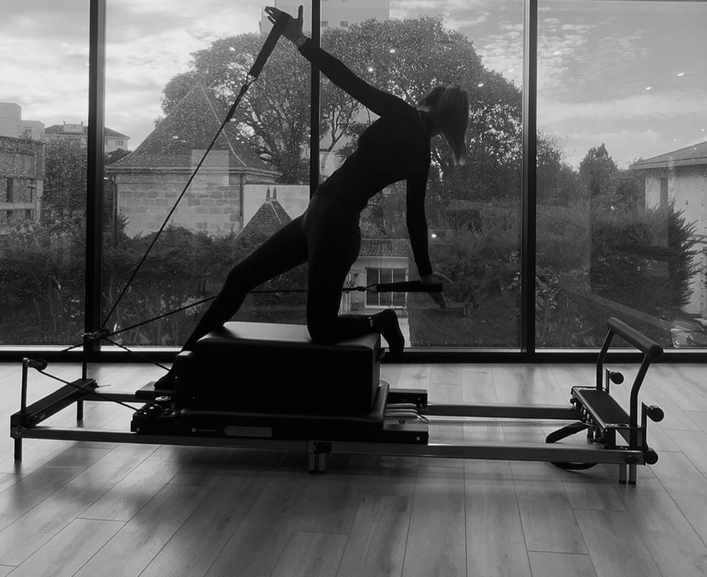 Séance de Pilates Reformer face à la fenêtre